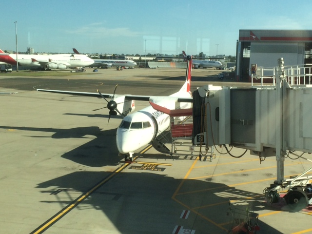 A Dash turboprop aircraft at the airport gate in Sydney.